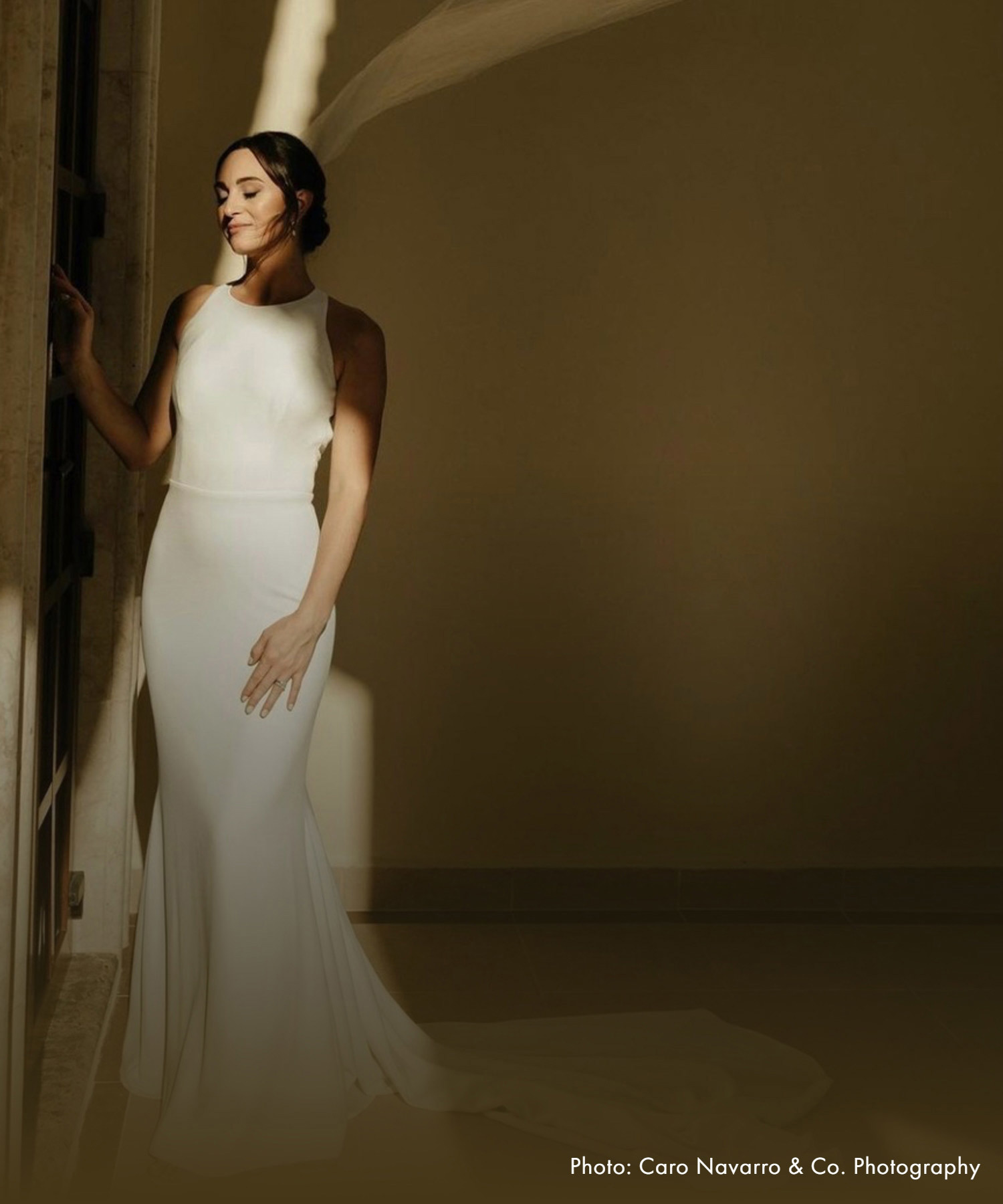 Model wearing a white gown. Mobile image