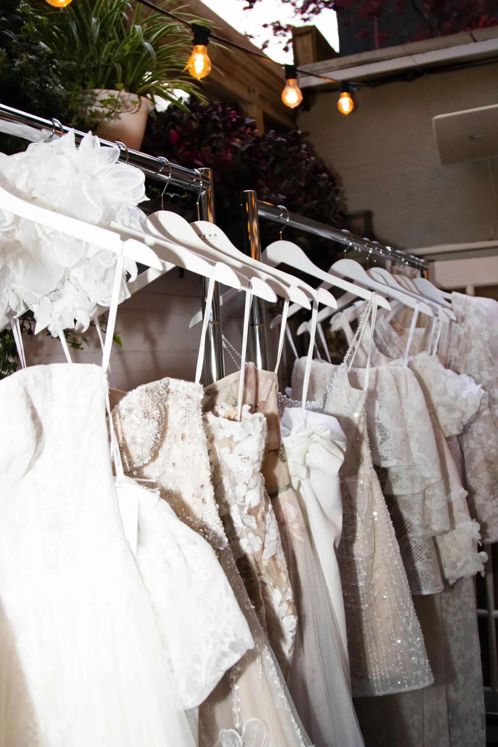 image shows a rack of mini bridal gowns