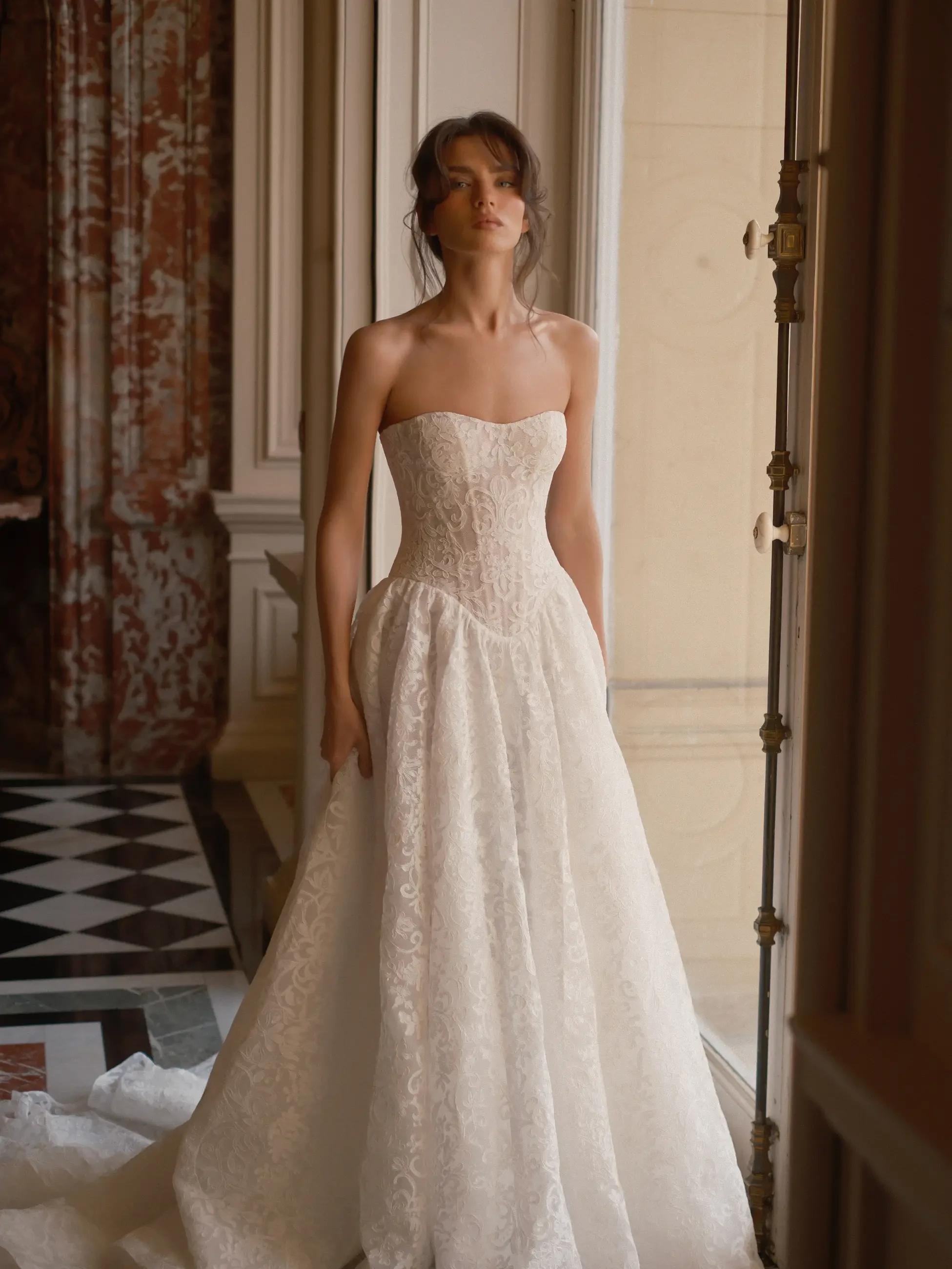 model is wearing a strapless basque wedding gown
