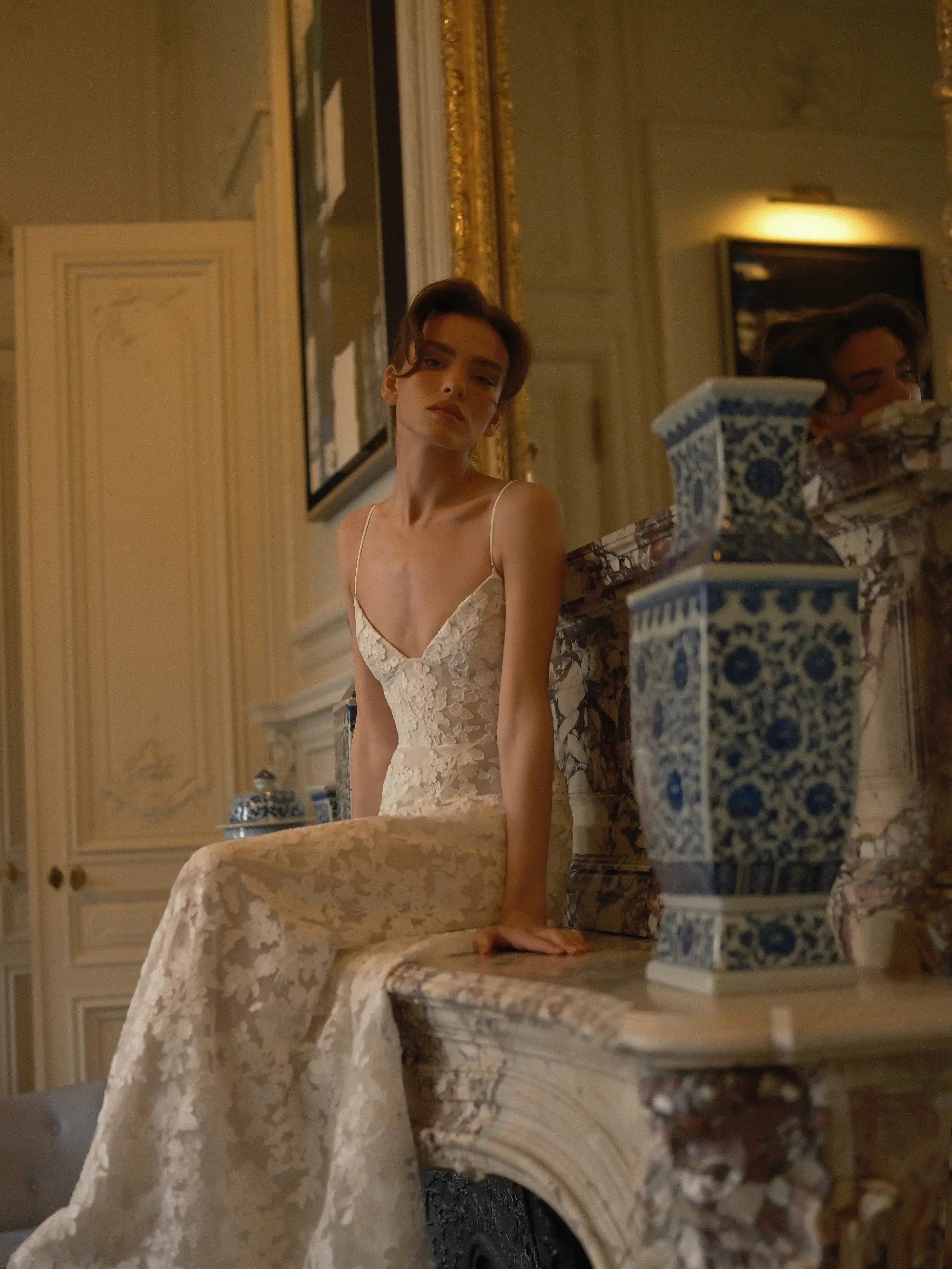 model is wearing a lace bridal dress