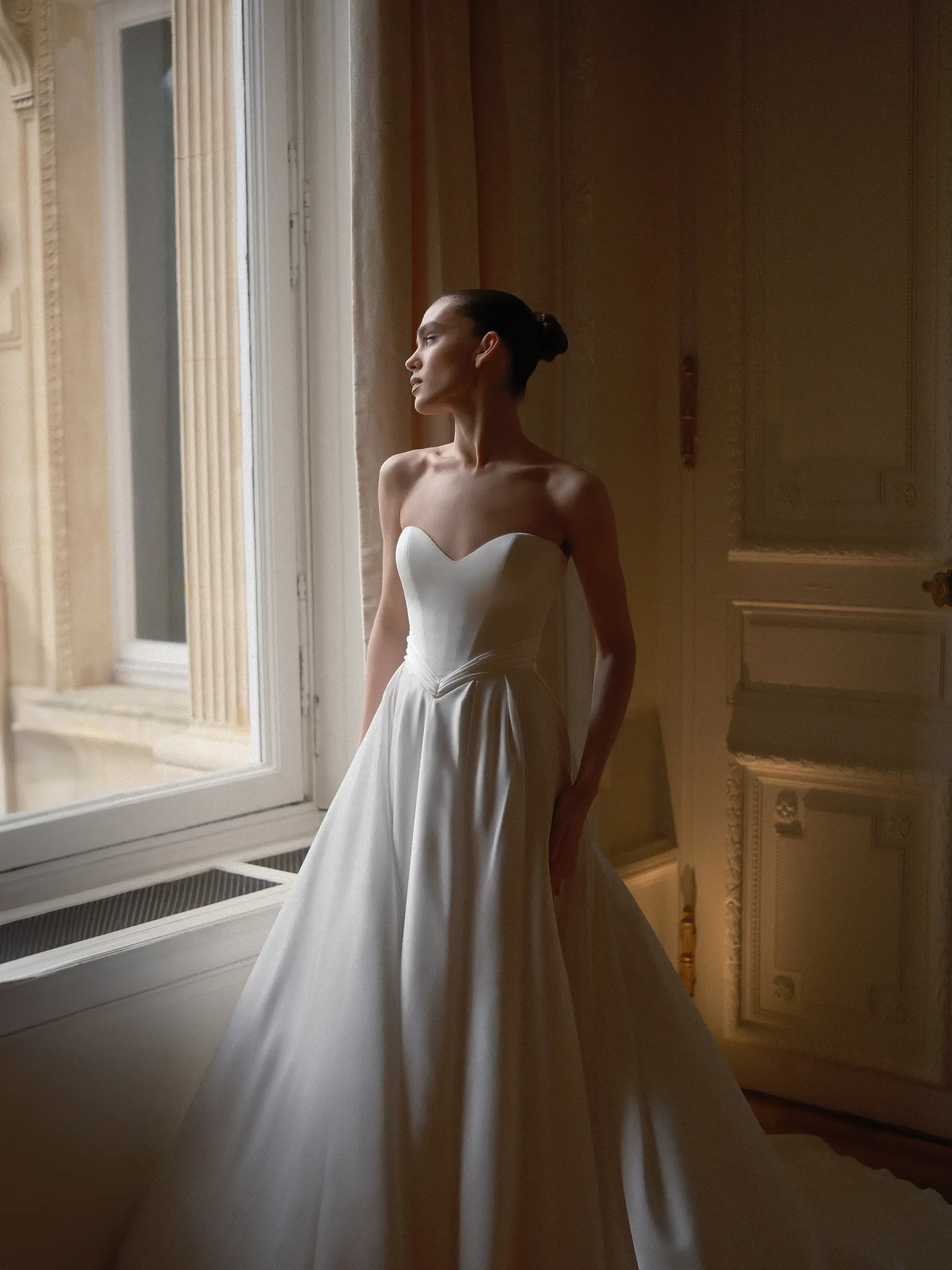 model is wearing a strapless a-line