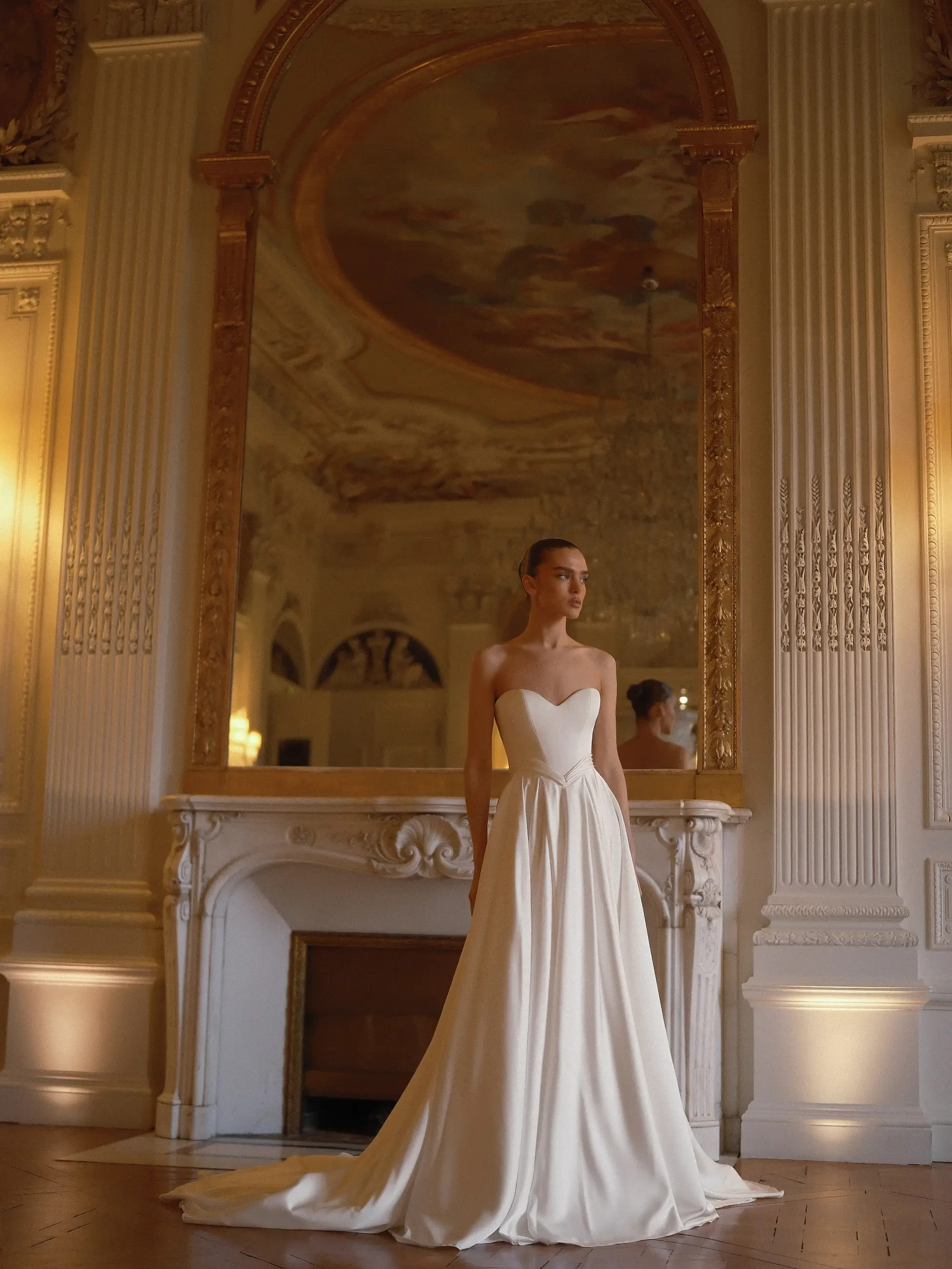 model is wearing a strapless a-line bridal gown