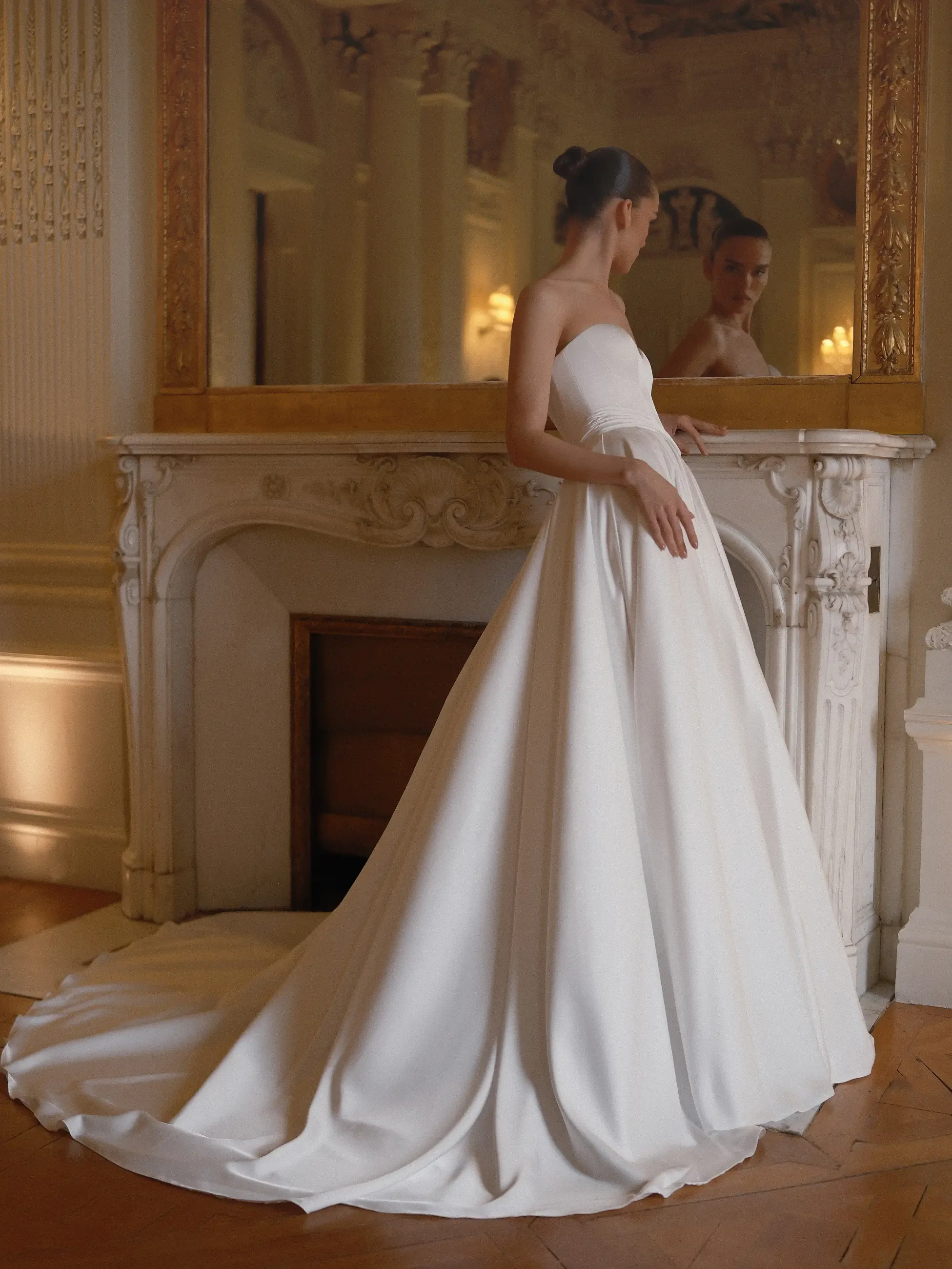model is wearing a strapless ball gown