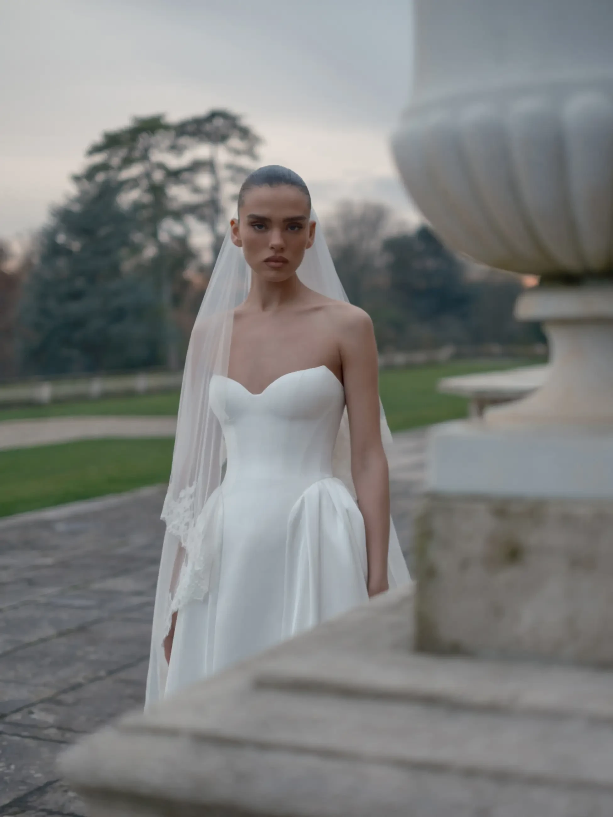 model is wearing a strapless ball gown
