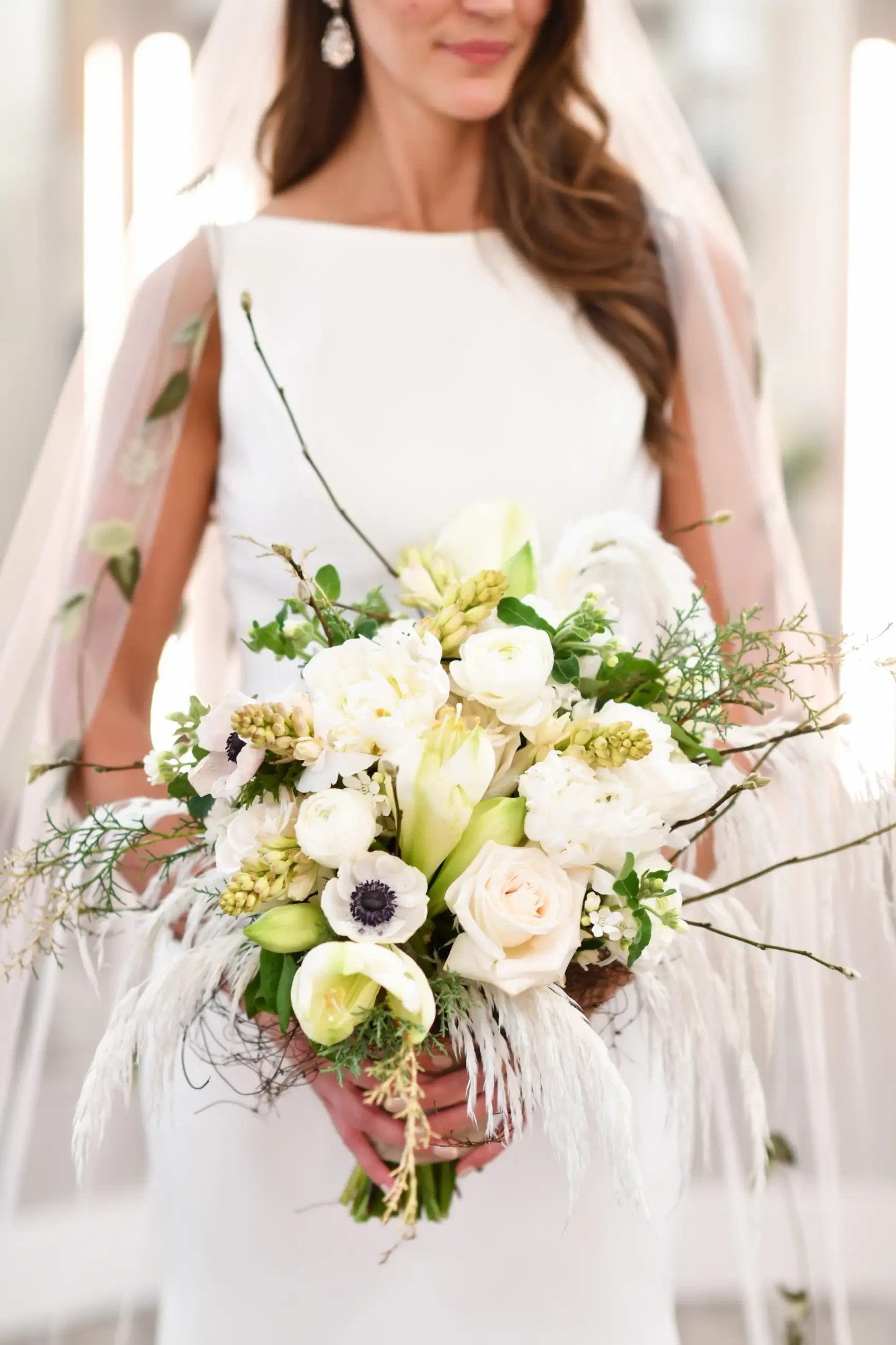image shows a bride holding a bouquet