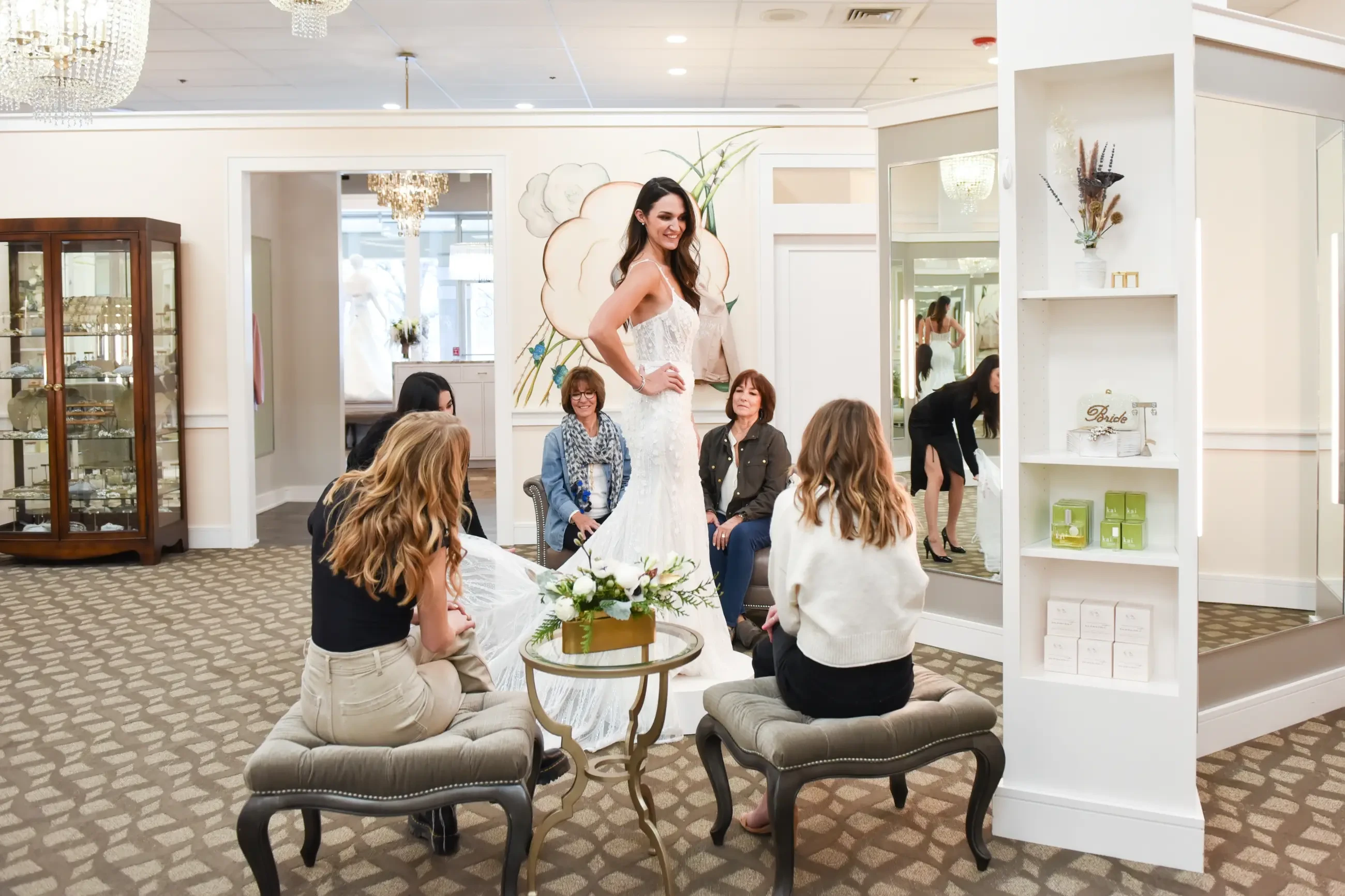image shows a bride trying on wedding dresses
