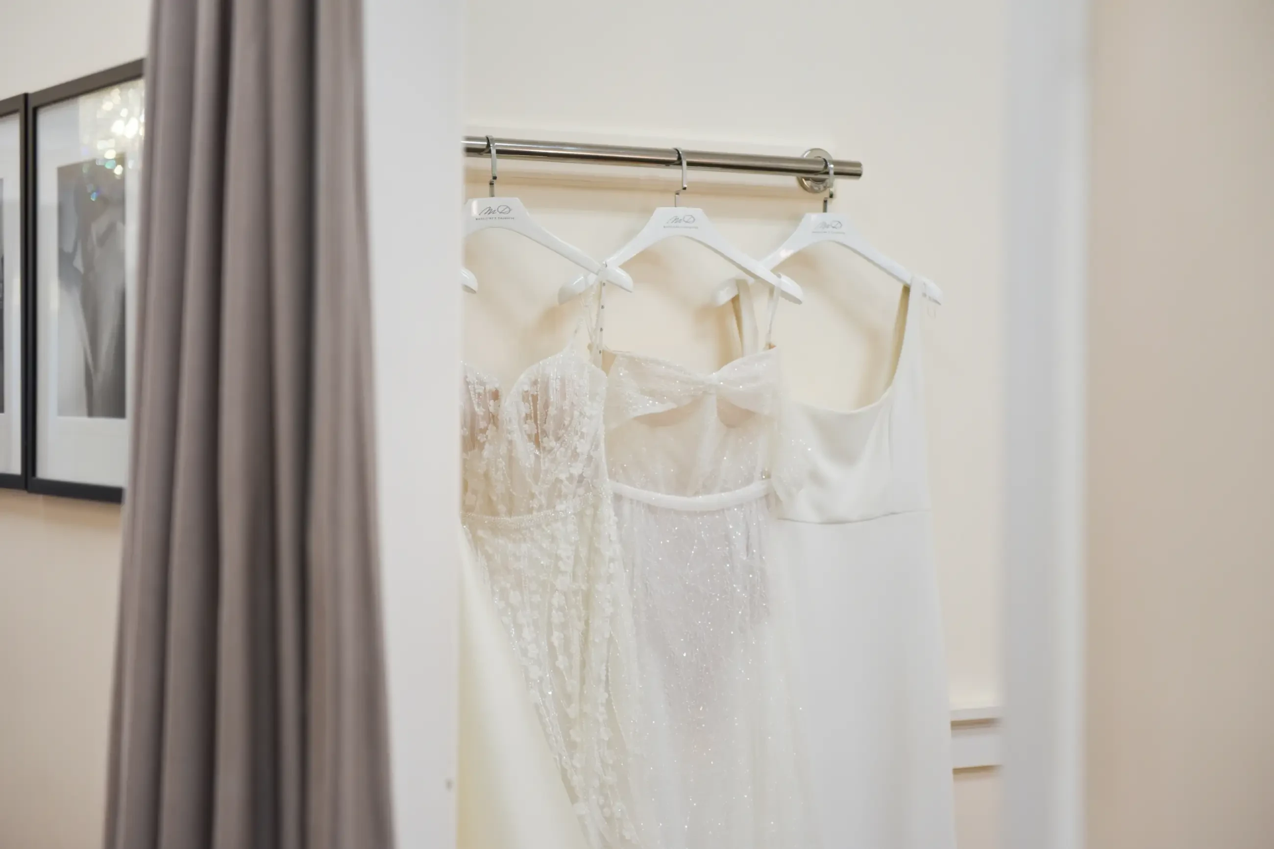 image shows wedding gowns hanging up