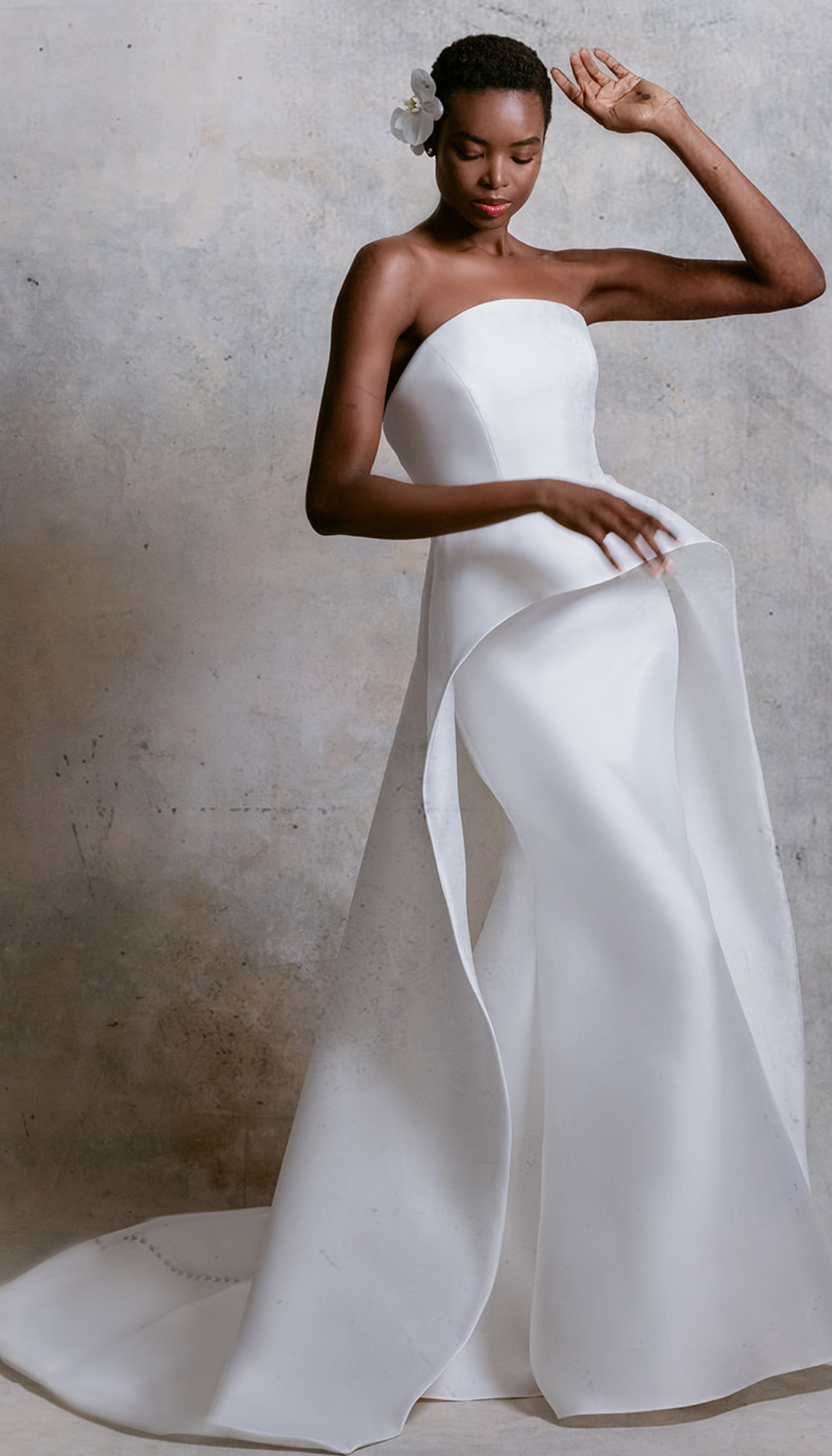 model is wearing a strapless sculpted bridal gown from mark ingram bridal