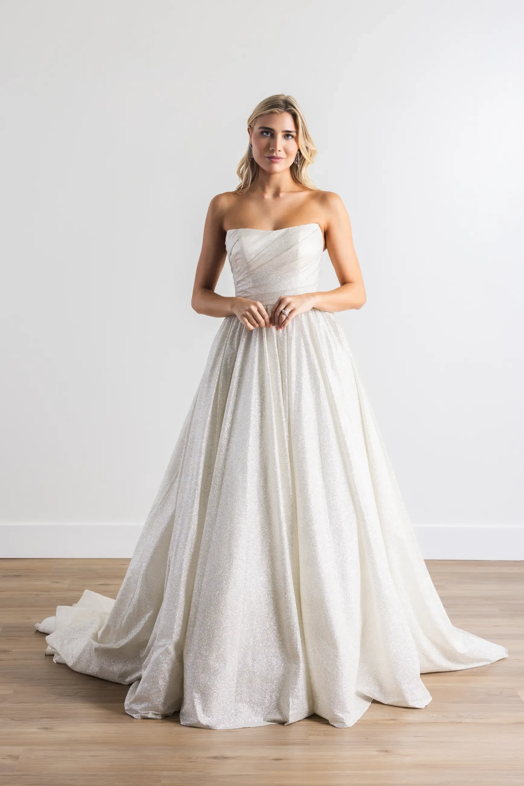 model is wearing a strapless a-line bridal gown