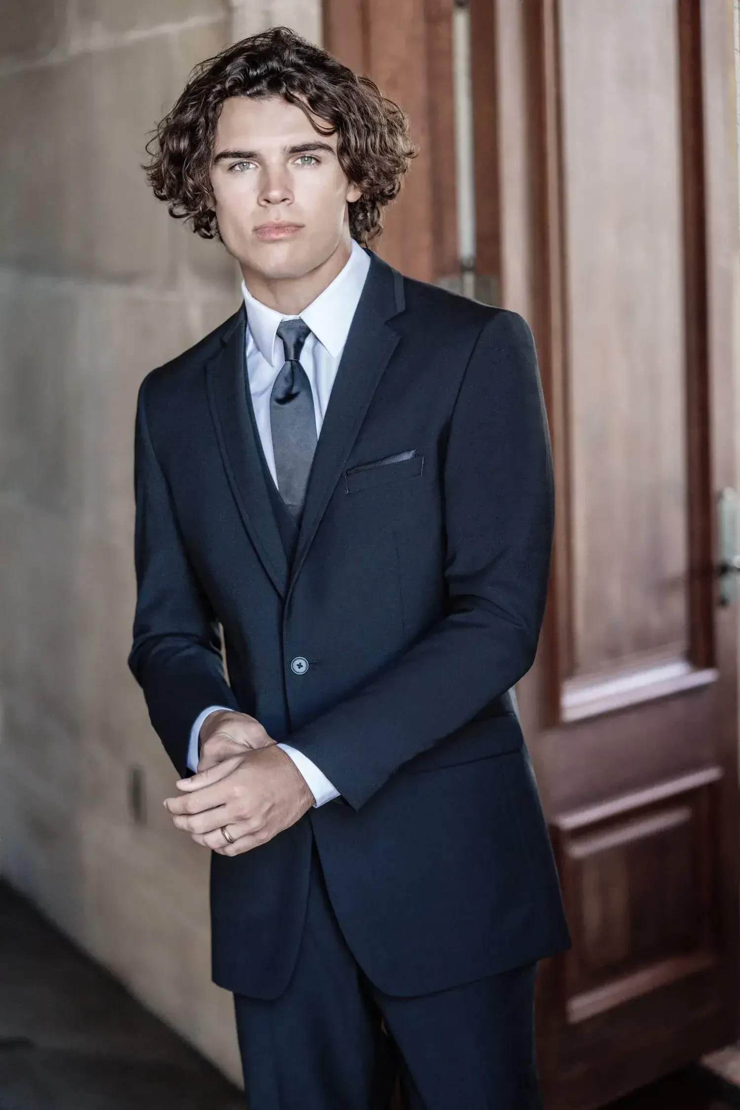 model is wearing a sleek suit from allure men