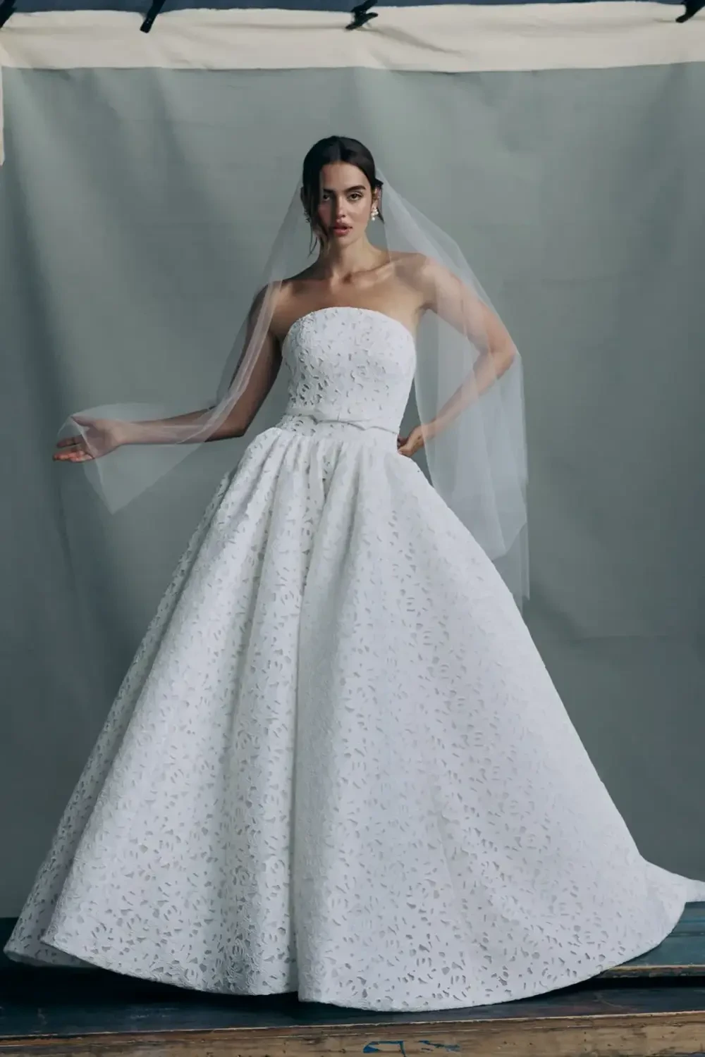model is wearing a strapless a-line bridal gown