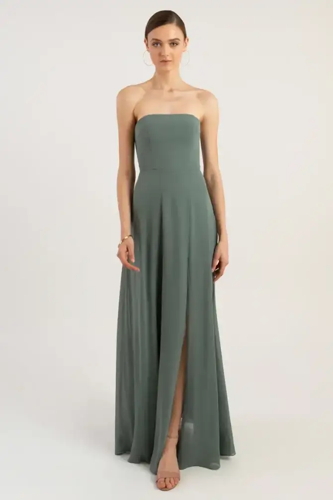 model is wearing a eucalpytus colored strapless bridesmaid dress