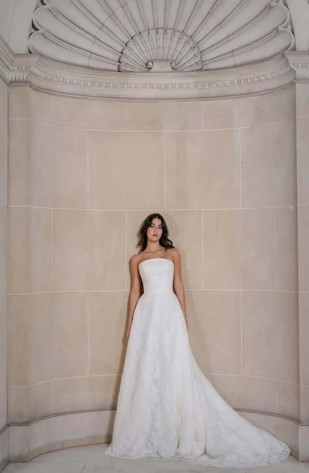 model is wearing a strapless a-line bridal gown
