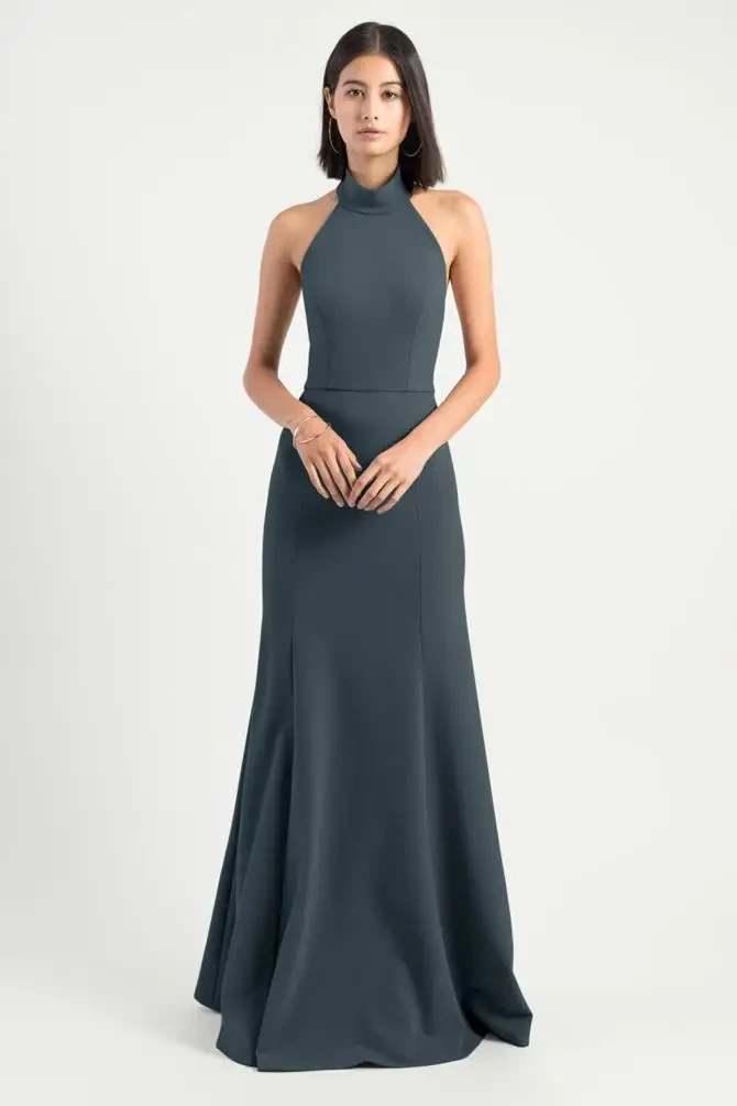 model is wearing a sleeveless high neck dark bridesmaid dress