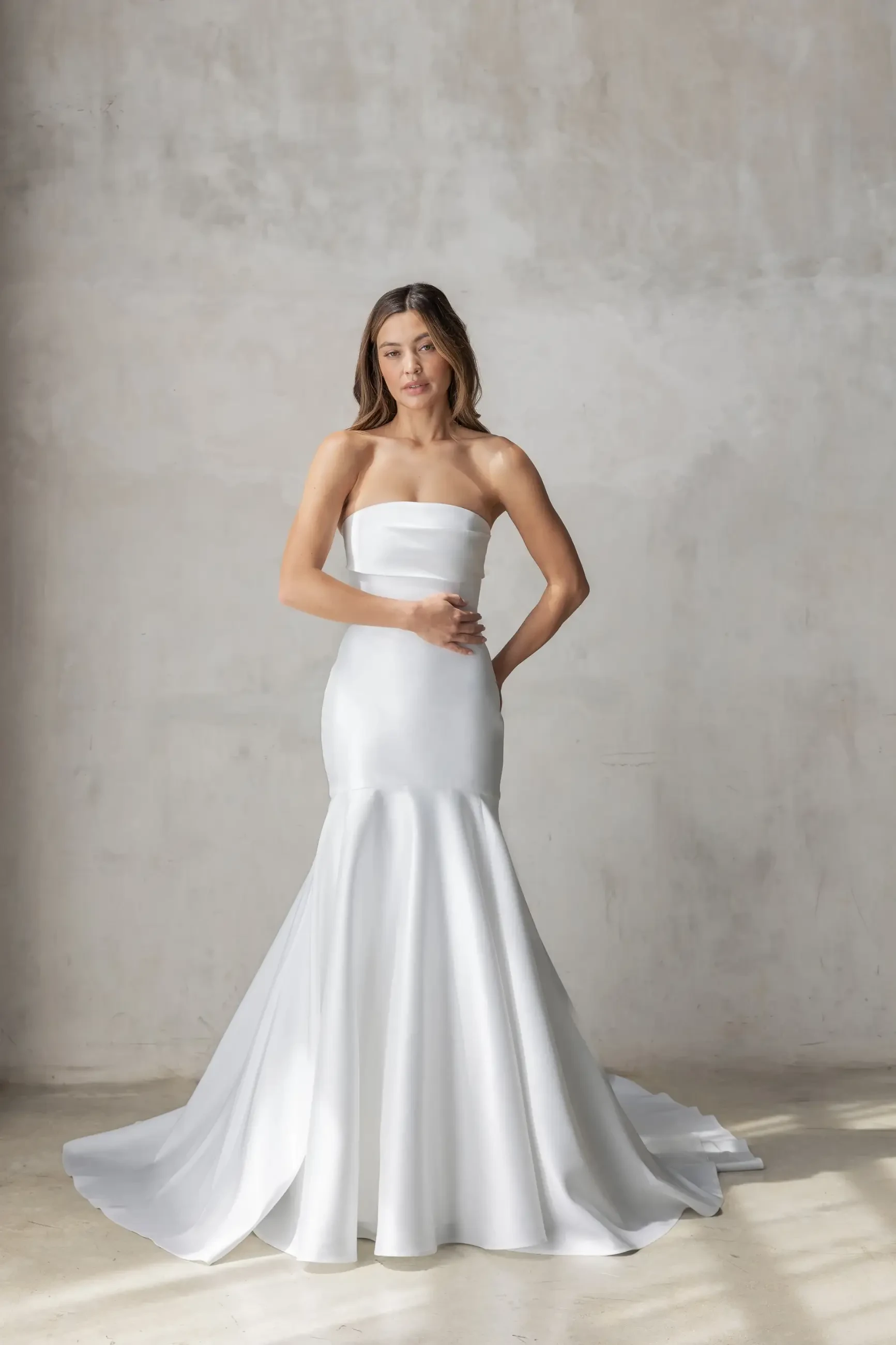 Model wears a strapless fit and flare gown in Spanish Mikado with a sleek mermaid silhouette.