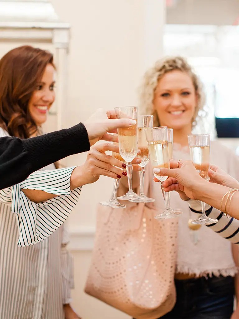 Photo of wedding party cheering with champagne